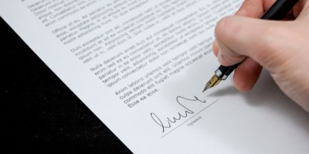 someone signing a document