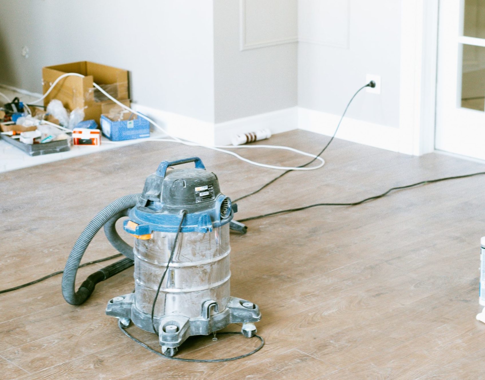 Shopvac vacuum on a dusty wood floor