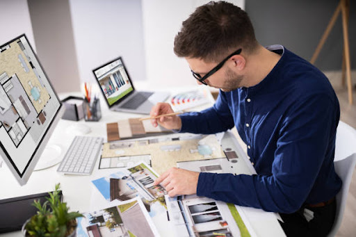 Real Estate Designer Working On Computer In Office
